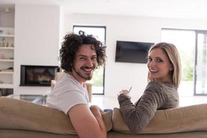 Rear view of couple watching television photo