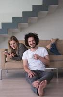 couple relaxing at  home with tablet computers photo