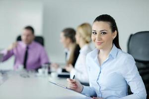 business woman standing with her staff in background photo