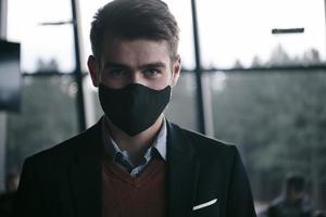 business man wearing protective face mask at luxury office photo