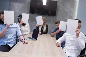 startup business team holding a white paper over face photo