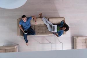 young multiethnic couple relaxes in the living room top view photo