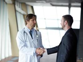 doctor handshake with a patient photo