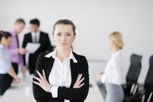 business woman standing with her staff in background photo