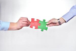 Group of business people assembling jigsaw puzzle photo