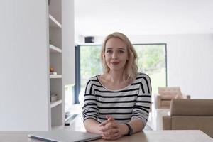 Young woman with laptop at home photo