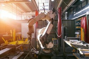 Turkey, 2022 - Automatic welding robot mechanical arm is working in the modern automobile parts factory. photo