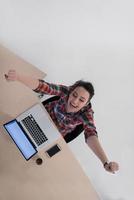 top view of young business woman working on laptop photo