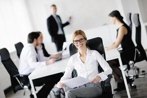 business woman with her staff in background photo