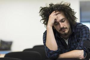 A student sits alone  in a classroom photo