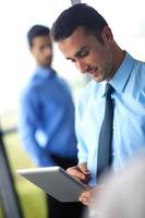 business man using tablet compuer at office photo