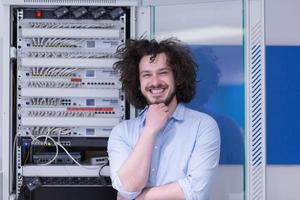 business man engeneer in datacenter server room photo