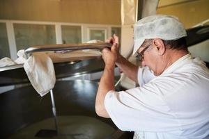 Cheese production cheesemaker  working in factory photo