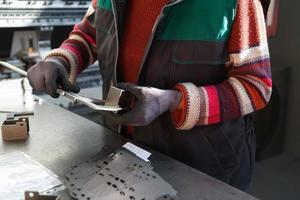 woman working in a modern factory and preparing materia for a CNC machine. photo