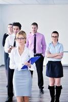 business woman standing with her staff in background photo