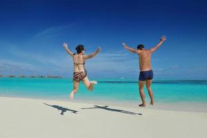 happy young  couple enjoying summer on beach photo