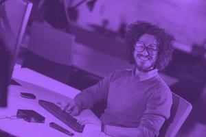 man working on computer in dark startup office photo