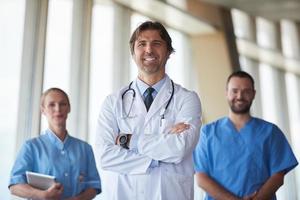 group of medical staff at hospital, handsome doctor in front of team photo