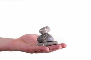 Man holding balanced zen rocks photo