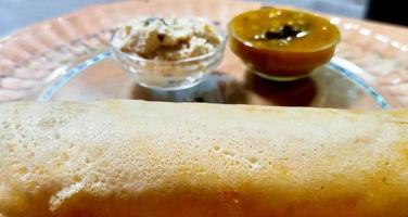 Paper Masala dosa is a South Indian meal served with sambhar and chutney photo