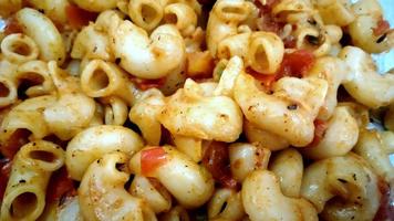 elbow macroni vegetable pasta in red tomato souce photo