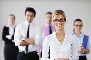 business woman standing with her staff in background photo