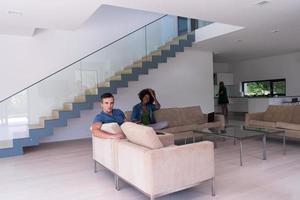 young multiethnic couple relaxes in the living room photo