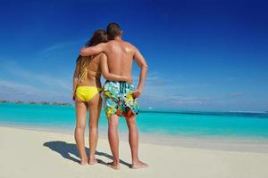 happy young  couple enjoying summer on beach photo