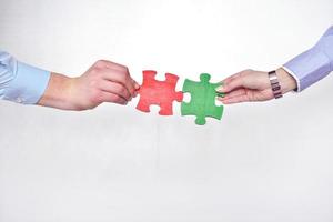 Group of business people assembling jigsaw puzzle photo