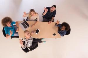 Multiethnic startup business team on meeting  top view photo