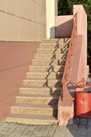 Yellow stone staircase in a high-rise building in the afternoon of a summer evening. photo