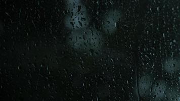 Rain drops on the glass. Small raindrop rests on glass while raining. video