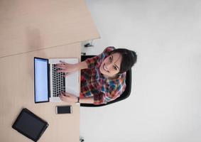 top view of young business woman working on laptop photo