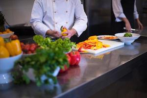 Chef cutting fresh and delicious vegetables photo