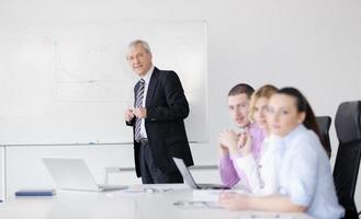 Senior business man giving a presentation photo
