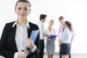 business woman standing with her staff in background photo