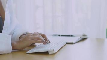 Closeup hand of young asian woman sexy in bra typing on keyboard computer, business woman is freelance work online to internet at home, social distracting, girl learning, lifestyle concept. video