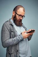 lifestyle brooding man with a beard and a telephone, background, copyspace. photo