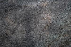 Abrasive texture roofing material close-up. Abstract dark granular background photo