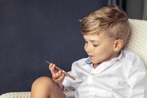 Cute boy watching cartoons on smart phone. photo