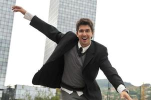 Outdoor portrait of young and happy  businessman photo