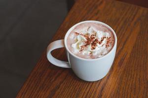 Hot chocolate with whipped cream and cacao powder. photo