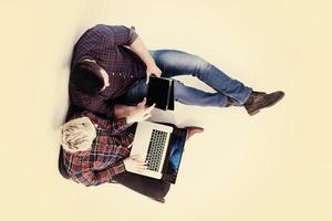 top view of  couple working on laptop computer at startup office photo