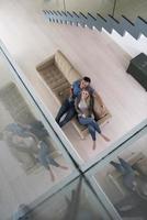 youg couple in living room with tablet top view photo