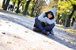 Cute young woman smiling outdoors in nature photo