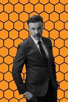 Black and white portrait of a stylish elegant senior businessman with a beard and casual business clothes against retro colorful pattern design background gesturing with hands photo