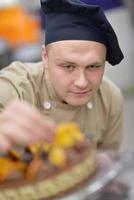 chef preparing desert cake in the kitchen photo