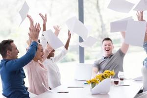 multiethnic startup Group of young business people throwing documents photo