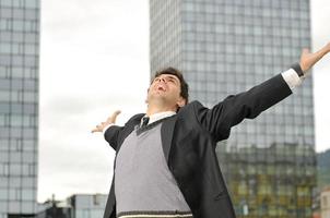 Outdoor portrait of young and happy  businessman photo