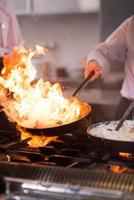 Chef doing flambe on food photo